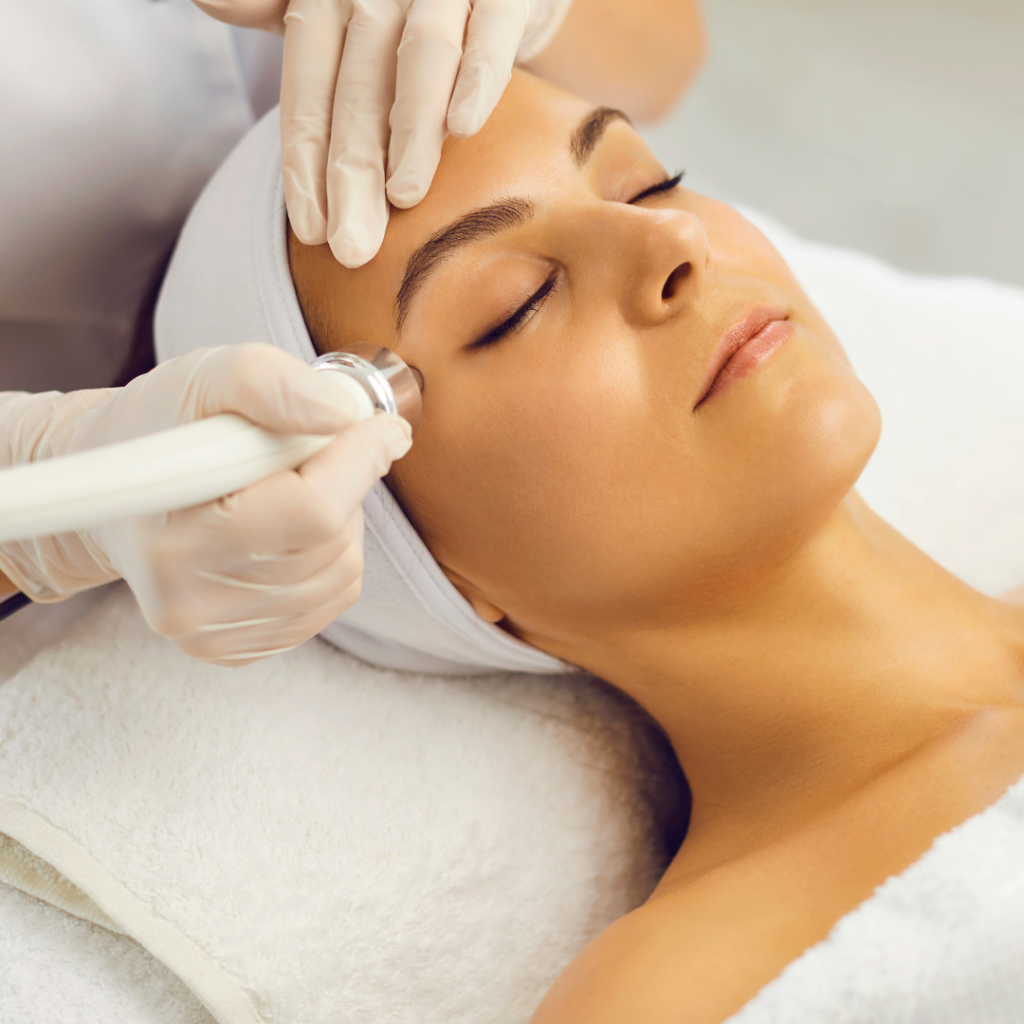 Woman receiving facial skincare treatment at spa.