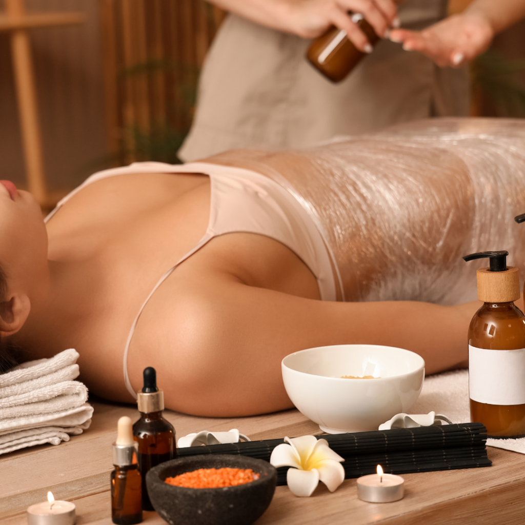 Woman receiving spa wrap treatment with oils.