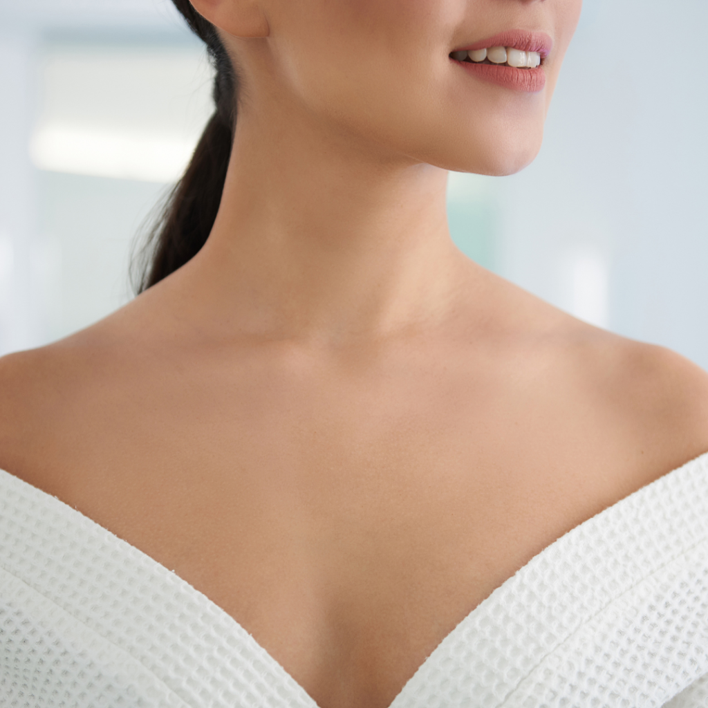 Woman smiling in white textured garment