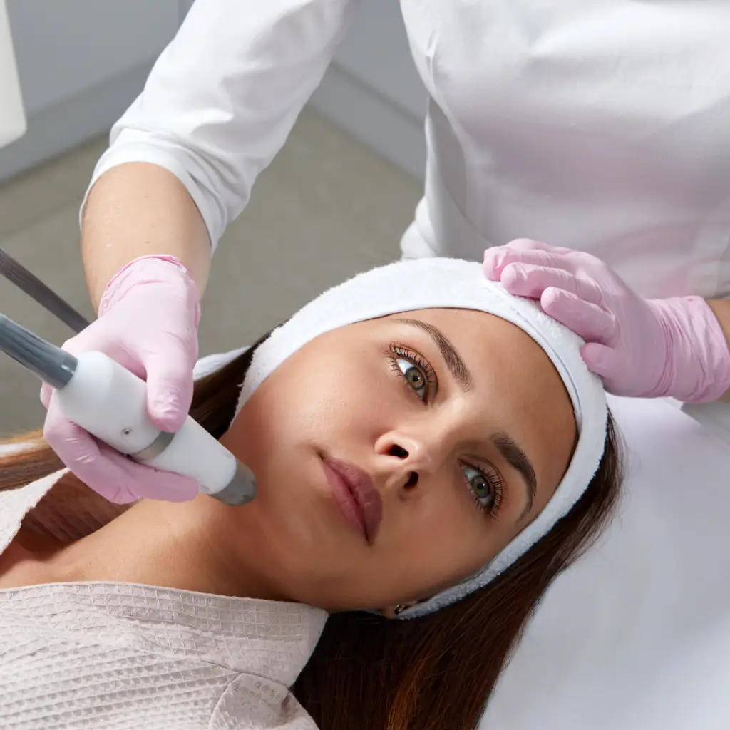 Woman receiving facial treatment at spa.