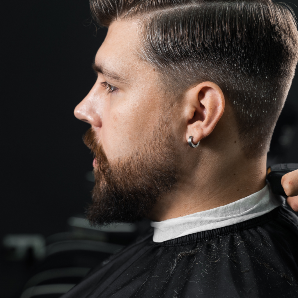 Man receiving a haircut at a barbershop.