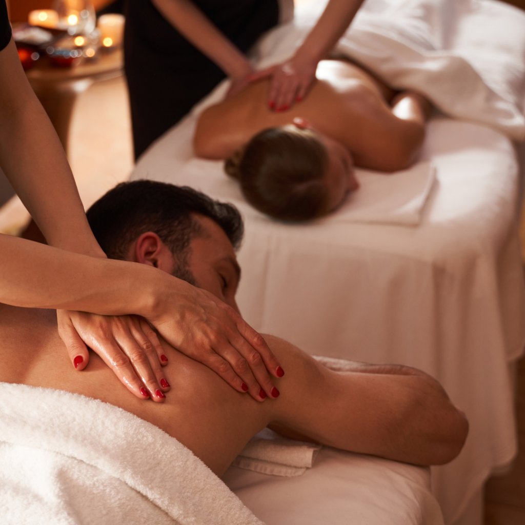 Couple receiving relaxing back massages at spa